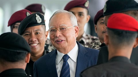 Former Malaysian Prime Minister Najib Razak arrives at the Kuala Lumpur High Court complex escorted by prison officers in Kuala Lumpur, Malaysia, April 4, 2024.