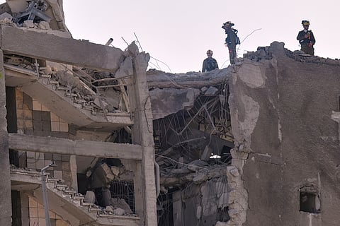 Israeli home front command units work in an unpopulated damaged building after it was hit by a missile fired from Iran.