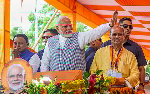 Prime Minister Narendra Modi with Odisha Chief Minister Mohan Charan Majhi during a programme organised to mark the completion of one year of the BJP government in the state (Photo | PTI)