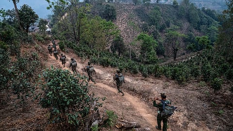 In this photo taken on March 9, 2023, members of ethnic rebel group Ta'ang National Liberation Army (TNLA) patrol near Namhsan Township in Myanmar's northern Shan State.