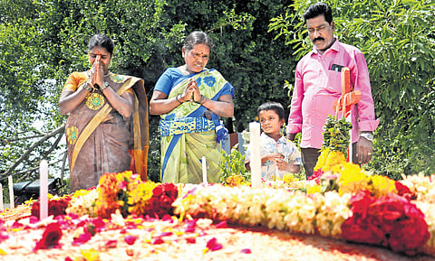Family members of Praveen pay tributes at his grave on the first death anniversary on Thursday