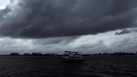 Dark clouds roll up in the sky above Kochi backwards.