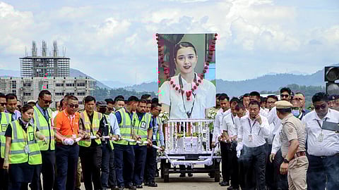 A cousin shared that floral tributes were paid by airport officials, family, and well-wishers upon her arrival.