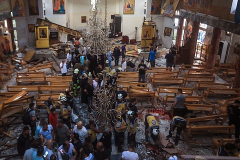 People and rescuers inspect the damage at the site of a reported suicide attack at the Saint Elias church in Damascus' Dwelaa area on June 22, 2025. Syrian state media reported a suicide attack on a Damascus church on June 22 that caused casualties, as AFP correspondents at the scene saw first responders transporting people from the site. 