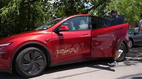 A rider boards a driverless Tesla robotaxi, a ride-booking service, Sunday, June 22, 2025, in Austin, Texas. 