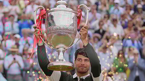 Carlos Alcaraz of Spain told up the winners trophy after defeating Jiri Lehecka of the Czech Republic, in the men's singles final of the Queens Club tennis championships in London, Sunday, June 22, 2025.