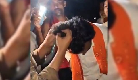 The viral video showing the upper caste men tonsuring the religious preacher in UP's Etawah. 