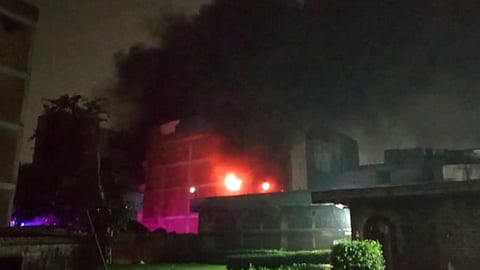 Smoke billows after a fire broke out at a factory, near Rithala metro station, in New Delhi, Tuesday night, June 24, 2025.