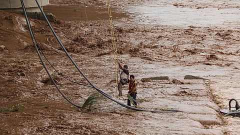 State Disaster Response Force (SDRF) team rescues a man stuck in the middle of Tawi river following flash flood after heavy rainfall, in Jammu, Wednesday, June 25, 2025