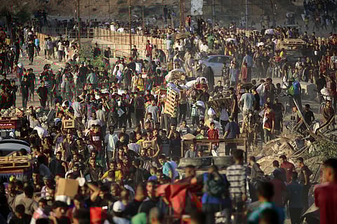 Palestinians gather at an aid distribution point set up by the Gaza Humanitarian Foundation (GHF), near the Nuseirat refugee camp in the central Gaza Strip on June 25, 2025.