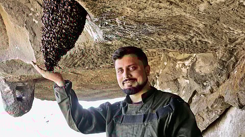 Amit Godse with a beehive