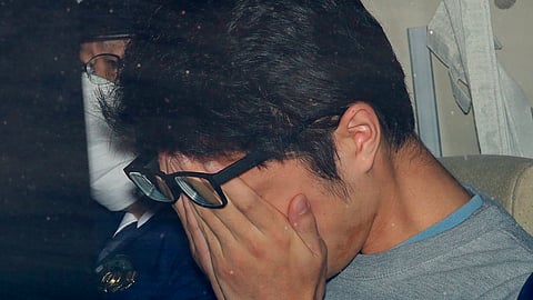 FILE - Takahiro Shiraishi leaves a police station in Hachioji, suburbs of Tokyo, in November 2017. 