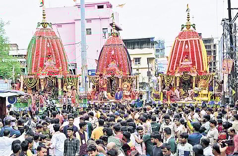 Devotees pull the chariots of the Trinity at Chandni Chowk in Cuttack.