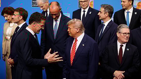 US President Donald Trump, centre, speaks with NATO Secretary General Mark Rutte, left, during a group photo of NATO heads of state and government at the NATO summit in The Hague, Netherlands, Wednesday, June 25, 2025.