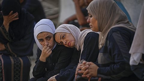Relatives of Palestinians killed in Israeli army strikes wait for their burials at Shifa hospital in Gaza City, Thursday, June 26, 2025. 