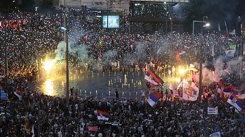 People wave their mobile phones with flashing lights during a major anti-government rally in Belgrade, Serbia, Saturday, June 28, 2025.