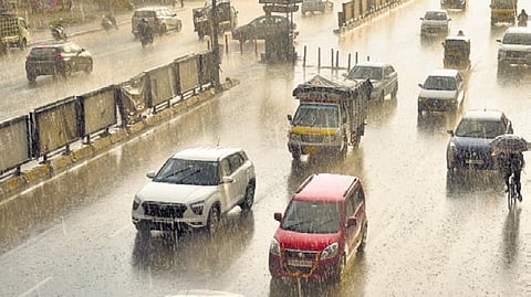 An aerial view of vehicles travelling through the rain.