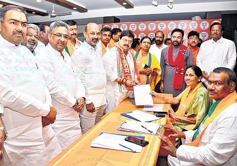 Former MLC N Ramchandar Rao filing his nomination for the state BJP president’s post in Hyderabad on Monday while senior party leaders look on