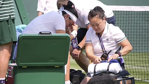 Ons Jabeur of Tunisia get medical assistance during her match against Varvara Gracheva of France at the first round singles match at the Wimbledon Tennis Championships in London, Monday, June 30, 2025.