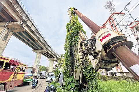 The tower crane lies abandoned on the Kaniyampuzha road at Vyttila as a stream of vehicles from the Vyttila Hub pass by 