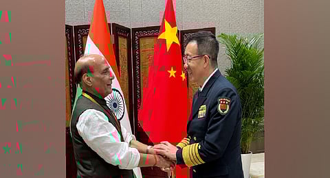 Defence Minister Rajnath Singh with Chinese counterpart Dong Jun in Qingdao. 