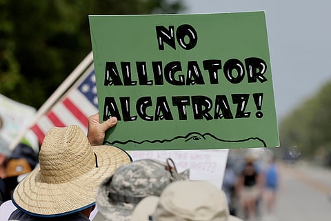 Environmental advocates and protesters at the Dade-Collier Training and Transition Airport on Tamiami Trail E, Ochopee, Fla., on Saturday, June 28, 2025, object to the "Alligator Alcatraz" being built at the facility.