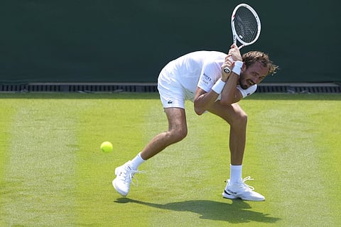 Daniil Medvedev of Russia returns the ball to Benjamin Bonzi of France during their first round men's single match at the Wimbledon Tennis Championships in London, Monday, June 30, 2025.