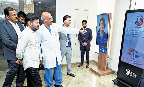 Chief Minister A Revanth Reddy is briefed by AIG chairman Dr D Nageshwar Reddy at the inauguration of a 300-bed hospital at Banjara Hills in Hyderabad on Wednesday