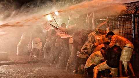 Police use water cannons on SFI activists during their protest in front of the Raj Bhavan on Wednesday.