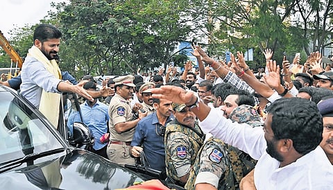 Chief Minister A Revanth Reddy greets his supporters after inaugurating the Malabar Gold and Diamonds manufacturing unit at Tukkuguda on Thursday