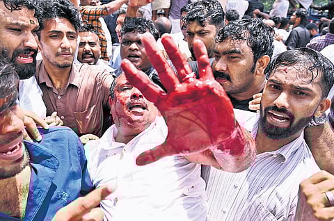 Youth Congress workers carry a person injured during the protest march to Kottayam Medical College Hospital on Friday.