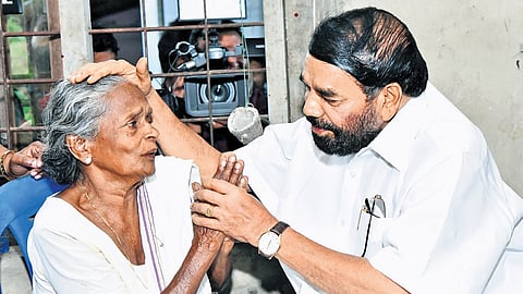 Minister V N Vasavan consoles Bindu’s mother Seethalakshmi at her residence in Thalayolapparambu.