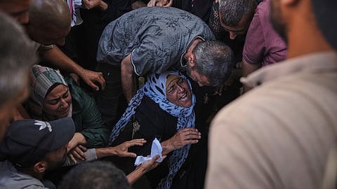 The mother of Anas Al-Basyouni mourns his loss shortly after he was killed while on his way to an aid distribution center, during his funeral at Shifa Hospital in Gaza City on Thursday, July 3, 2025.