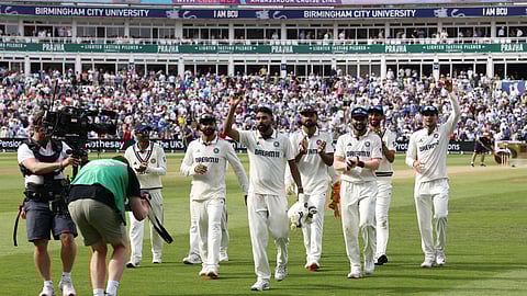 India's Mohammed Siraj (C) is congratulated as he leaves the field having taken six wickets, on day three of the second cricket test match between England and India at Edgbaston cricket ground in Birmingham, central England on July 4, 2025. 