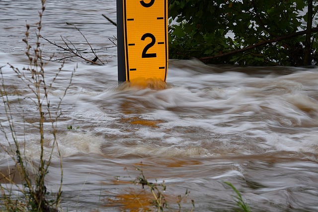 A flood gauge marks the height of water flowing over a farm-to-market road near Kerrville, Texas, on Friday, July 4, 2025.