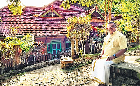 Abraham sits in front of Oor, one of the best models of sustainable architecture in the country.