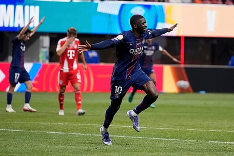 PSG's Ousmane Dembele (R) celebrates scoring his team's second goal with Desire Doue during the FIFA Club World Cup 2025 semifinal football match between PSG and Real Madrid on July 9, 2025. 