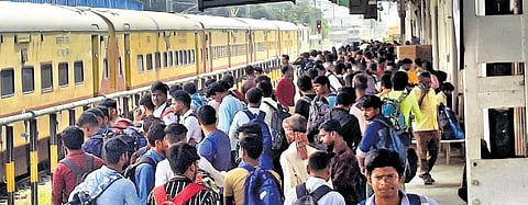 Passengers waiting to board a train at Chennai Egmore railway station 