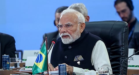 Brazilian President Luiz Inacio Lula da Silva, left, Indias Prime Minister Narendra Modi, center, and Chinas Premier Li Qiang take part in a group photo during the 17th annual BRICS summit in Rio de Janeiro, Monday, July 7, 2025