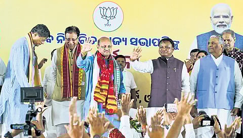 CM Mohan Charan Majhi and Manmohan Samal wave at party workers at the BJP office, in Bhubaneswar on Tuesday.
