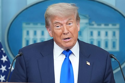 US President Donald Trump speaks to the media as he leaves the White House, Tuesday, July 15, 2025, in Washington, as White House press secretary Karoline Leavitt, looks on.