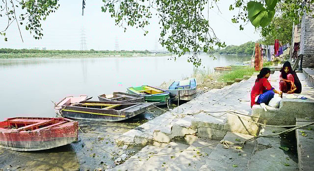 A scenic view of Nigambodh Ghat, where boats are anchored in Yamuna.