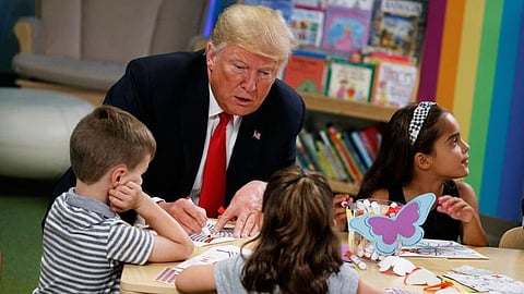 President Donald Trump colors during a visit with a group of children at the Nationwide Children's Hospital, Aug. 24, 2018, in Columbus, Ohio.