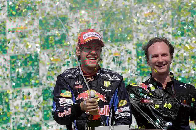 Red Bull driver Sebastian Vettel, of Germany, celebrates as Red Bull team principal Christian Horner looks on at the podium after winning Brazil's Formula One Grand Prix at the Interlagos race track in Sao Paulo, Brazil, Sunday Nov. 7, 2010. 