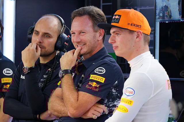 Red Bull team principal Christian Horner, center, smiles next to his driver Max Verstappen of the Netherlands, right, during the first practice session for the Malaysian Formula One Grand Prix at Sepang International Circuit in Sepang, Malaysia, Friday, Sept. 29, 2017.
