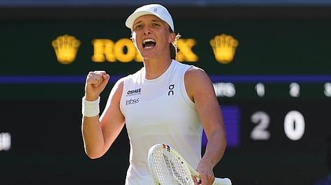 Iga Swiatek of Poland celebrates winning the women's singles semifinal match against Belinda Bencic of Switzerland at the Wimbledon Tennis Championships in London, Thursday, July 10, 2025.
