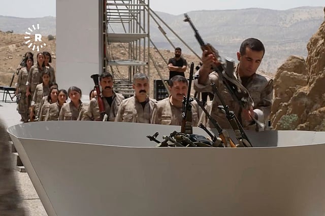 This frame grab from a video released by Rudy TV shows PPK (Kurdistan Workers' Party) fighters during a symbolic disarmament ceremony as part of the peace process with Turkey, in Sulaymaniyah governorate, in Iraq's semi-autonomous Kurdish region, Friday, July 11, 2025.
