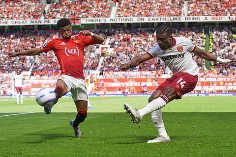 West Ham's Mohammed Kudus, right, kicks the ball ahead of Manchester United's Amad Diallo during the English Premier League soccer match at Old Trafford stadium in Manchester, England, May 11, 2025.