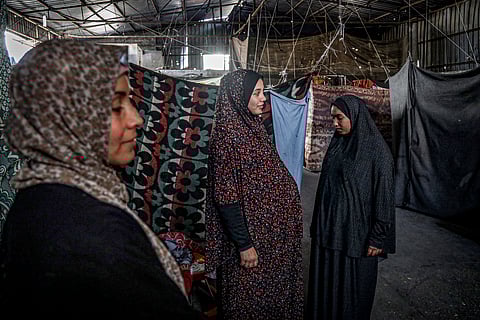 Mourners attend the funeral of their relatives who were killed in an Israeli bombardment, in Deir al-Balah, Gaza Strip, Saturday, July 12, 2025