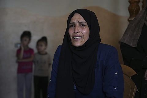 Mourners attend the funeral of their relatives who were killed in an Israeli bombardment, in Deir al-Balah, Gaza Strip, Saturday, July 12, 2025